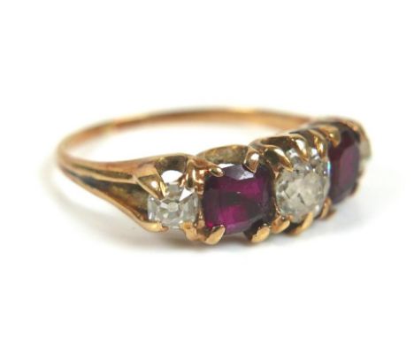 A diamond, ruby and gold five-stone ring, the central oval faceted cut diamond, 5 by 4 by 3mm, flanked by two rubies, and two