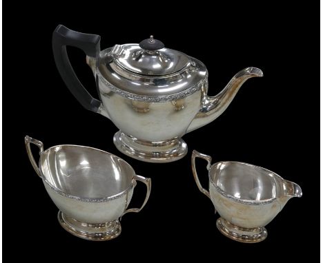 A George VI three-piece tea set, comprising tea pot with ebony finial and handle, 28 by 11 by 17cm high, a milk jug and a twi