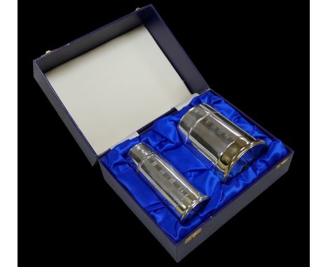 An ERII cased silver cigarette holder, 9.5 by 12cm high, a cigarette table lighter, 6 13.8cm high, both of cylindrical form, 