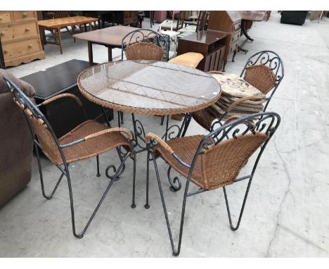 A HEAVY WROUGHT IRON PATIO TABLE AND FOUR MATCHING CHAIRS 