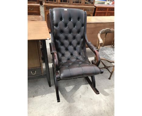 A MAHOGANY AND BUTTON BACK LEATHER ROCKING CHAIR 