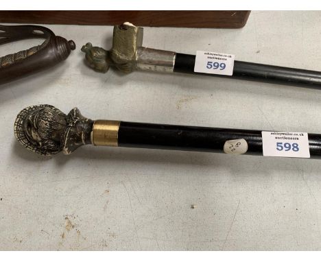 A METAL HEAD SCREW TOP WALKING STICK WITH GLASS BOTTLE INSIDE 