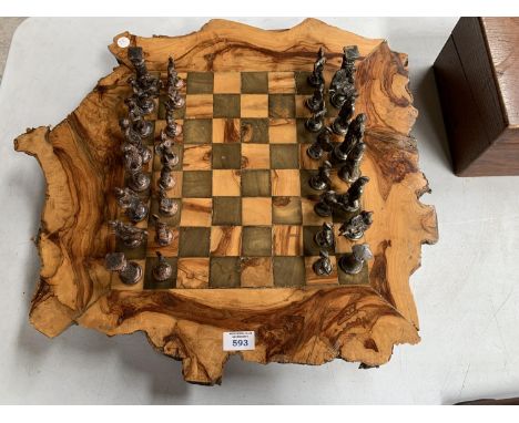 AN INDIAN CHESS SET, BOARD MADE FROM A TREE TRUNK WITH METAL PIECES 