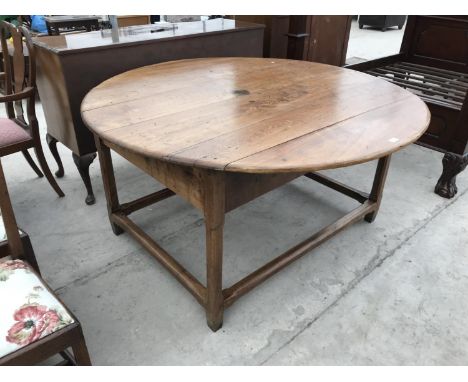 A CIRCULAR FRENCH OAK DINING TABLE 