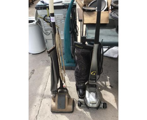A KIRBY G SIX PERFORMANCE CLEANER AND A VINTAGE VACUUM CLEANER 