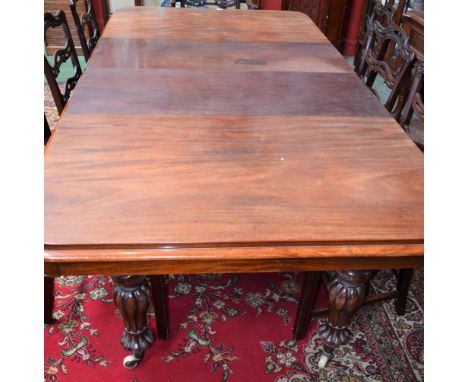An early Victorian mahogany rounded rectangular pull-out dining table, moulded top above a deep frieze, fluted baluster legs,