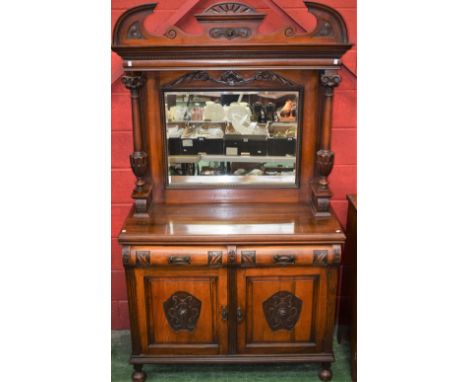 An Arts and Crafts style mahogany mirror-back sideboard, broken arch cresting above a rectangular bevelled plate flanked by I