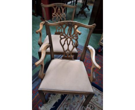 A pair of Chippendale Revival open armchairs, each with a cupid's bow cresting rail applied with ribbon-tied foliage, pretzel