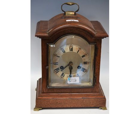 An oak bracket clock, silvered dial, Roman and Arabic numerals, 35cm high over handle