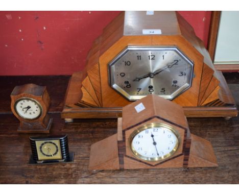 Clocks - an Art Deco inlaid walnut veneered mantel clock, silvered elongated octagonal dial, Arabic numerals, chiming four ba