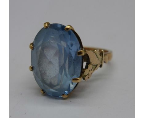 A yellow metal and blue stone ring, 5.8g, N