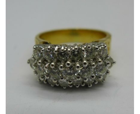 An 18ct gold and diamond ring, set with nineteen diamonds, 9.7g, O