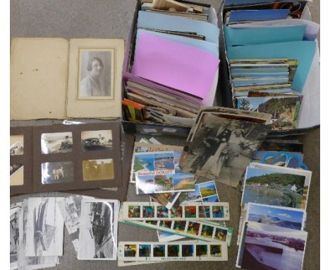 A box of postcards and a box of black and white photographs, souvenir postcard albums, etc., and eight Chad Valley colour sli