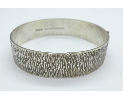 A 1970's bark effect silver bangle