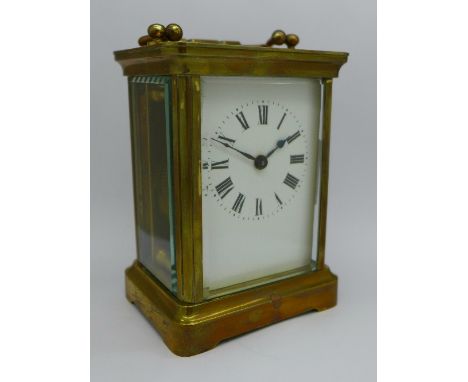 A brass carriage clock, the top bears inscription, From "The Queen's" Regt., Bermuda 1914