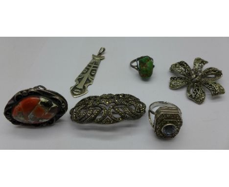 A silver, stone set ring watch, two silver stone set rings, two brooches and a pendant
