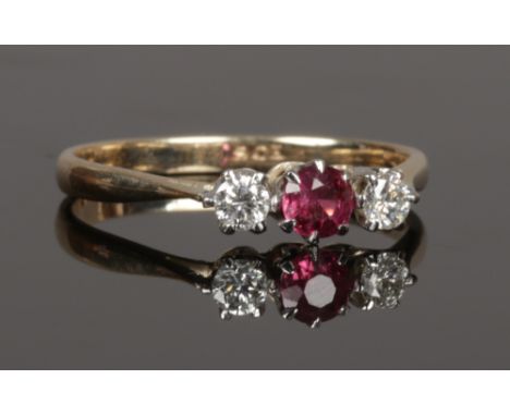 A 9ct gold ruby and diamond three stone set ring, size O 1/2.