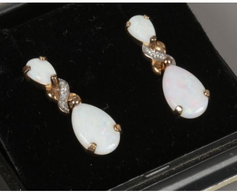 A pair of 9ct gold opal and diamond pendant earrings.