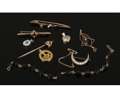 A collection of 9ct gold jewellery pieces including a masonic fob, diamond set stick pin and a garnet and seed pearl bar broo