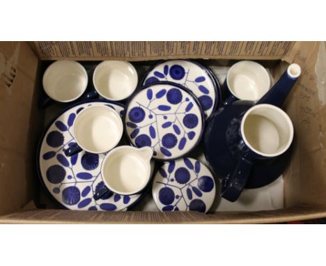 A German coffee set with blue ground and stylised floral decoration including coffee pot (lacking lid) cups and saucers, crea