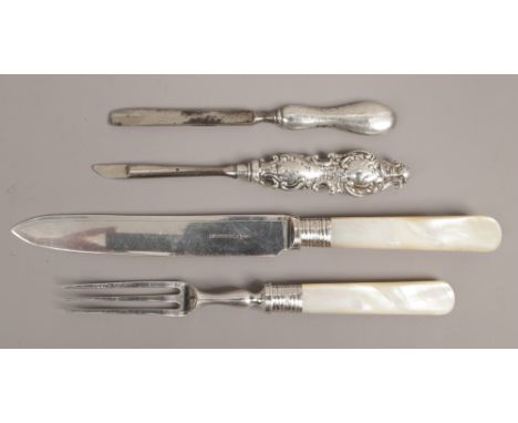 A quantity of silver mounted items including mother of pearl handled knife and fork etc.