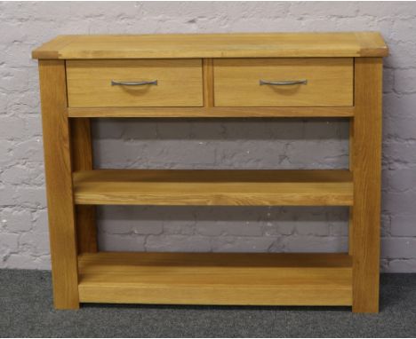 A light oak two drawer side table with two under tiers&nbsp;