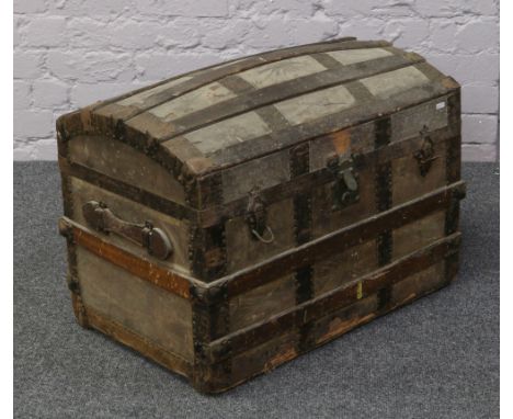 A metal bound wood travel trunk with fitted interior top.