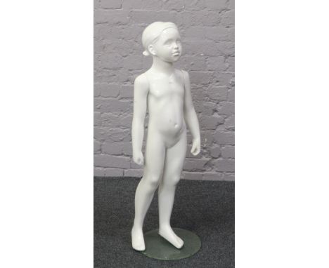 A shop display mannequin on stand formed as a child.