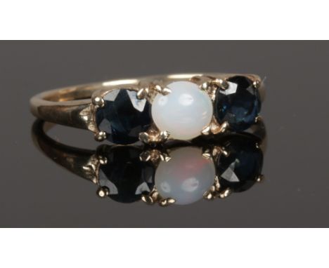 A 9ct gold opal and sapphire three stone ring, size O.