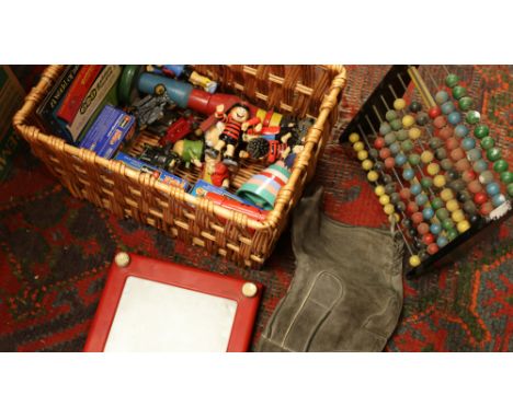 A wicker basket of children's toys to include etch-a-sketch screen, Abacus, figurines etc.
