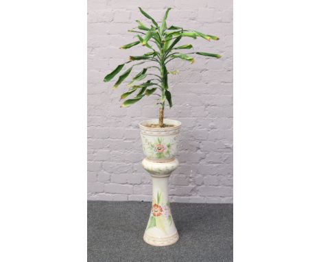A Portuguese ceramic jardiniere on stand decorated with flowers planted with a Yucca tree.
