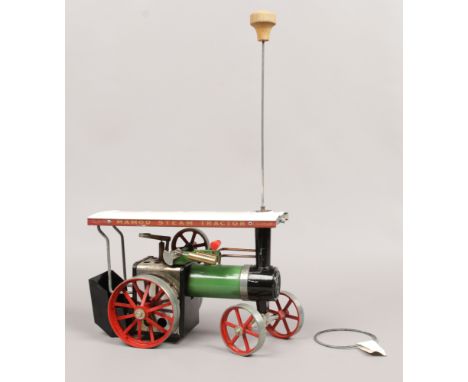 A Mamod TE1A live steam traction engine with steering rod, burner box and spare drive band.