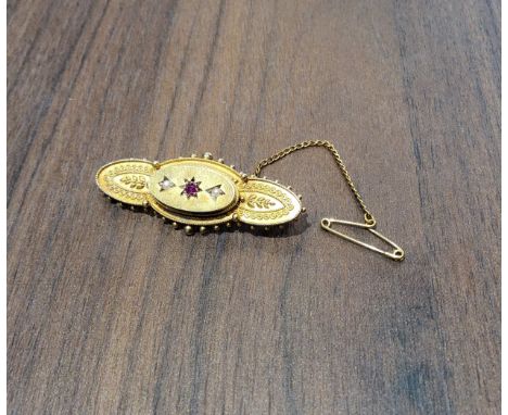 A Victorian 15ct gold bar brooch, set with a central ruby and seed pearls, 4.5cms 4.27g gross 