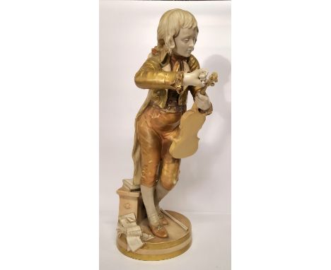 A large Royal Worcester figure, The Violinist/The Young Mozart, possibly modelled by Thomas Brock, standing tuning his instru