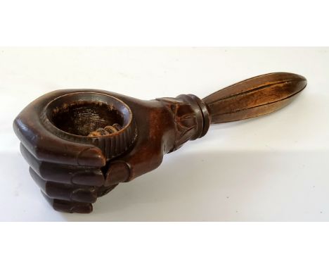 Treen - an unusual 19th century Swiss carved wood nut cracker in the form of closing hand, turn shaft mechanism exposing carv