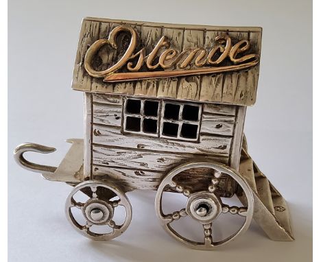 A continental white metal possibly German miniature of bathing machine with applied yellow metal script to roof 'Ostende', fl