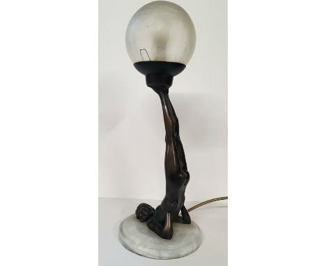 An Art Deco type bronzed table lamp, with gymnastic pose column, frosted globe shade. 