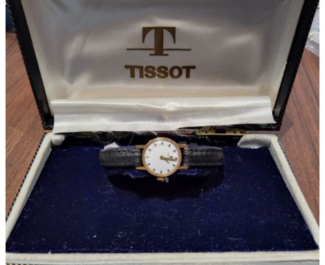 An 18ct gold lady's Tissot watch, Swiss movment, silver dial, gold &amp; black batons, later black leather strap, n/o in orig