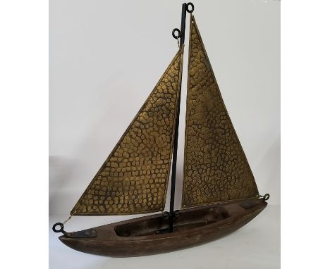 A vintage hand beaten brass and wood yacht model. approx 50cm high. 
