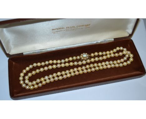 A pearl necklace with opal and pearl clasp