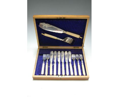 An early 20th century walnut cased canteen containing pair of fish servers, and six place setting of fish knives and forks wi