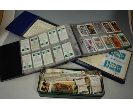 An album of Coronation anniversary first day covers from the Pobjoy mint limited together with various cigarette cards and co