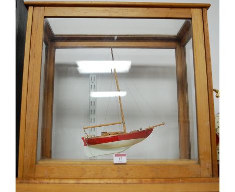 A small scale model of a 7 ton Bermudan sloop in associated display case