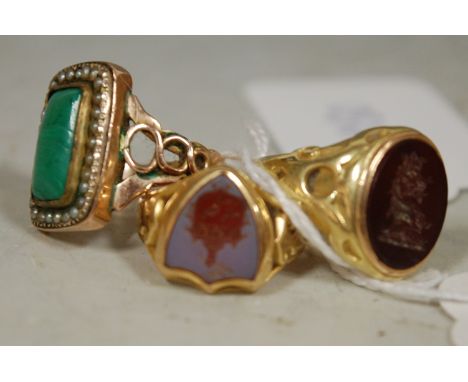 A gents 18ct gold agate set signet ring; one other yellow metal hardstone set signet ring; and a ladies yellow metal malachit