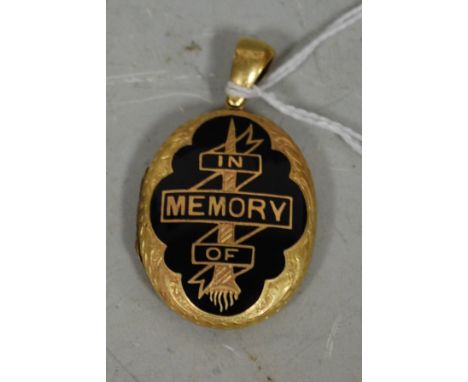 A Victorian pinchbeck and black enamel mourning picture locket