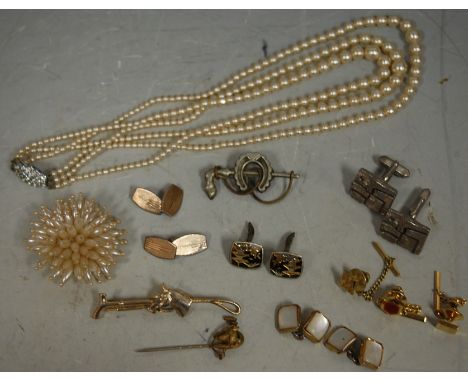 A bag of assorted costume jewellery to include; faux pearl necklace, tie-pins, cufflinks etc 