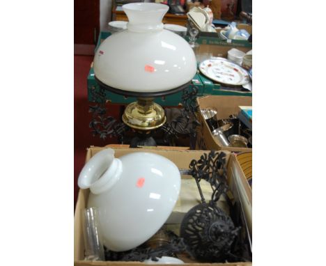 A Victorian style pedestal oil lamp, having opalescent glass shade, brass reservoir and iron base; together with a similar ha