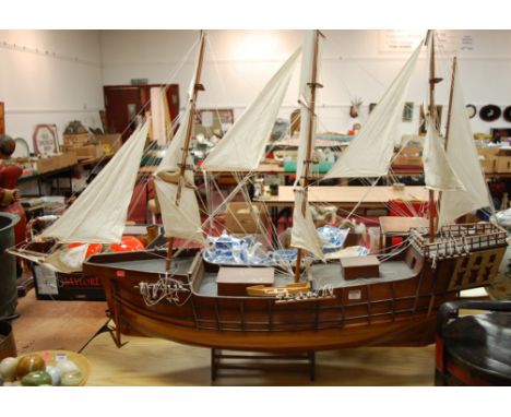 A large rosewood scale model of a three-masted galleon