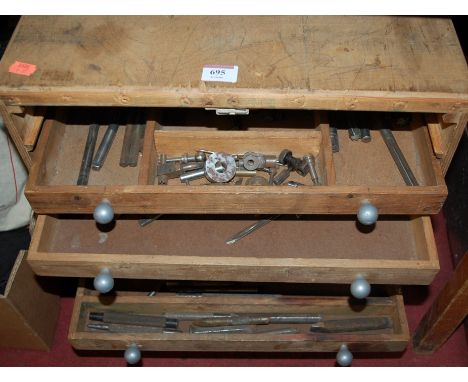 An early 20th century 7 drawer pine tool chest and contents to include various drill bits