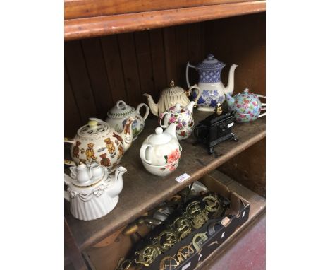 SHELF OF POTTERY NOVELTY TEAPOTS